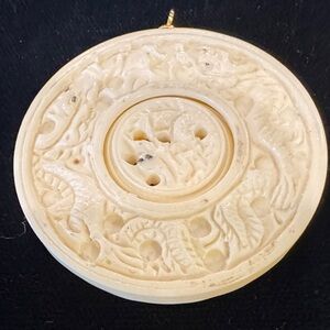 Carved Faux Ivory Disc Pendant With Dragon Design and Rotating Inner Disc